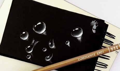 water drop sketch on black paper