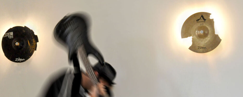 Close-up of cracked cymbal texture on a handmade lamp, showing unique signs of wear.