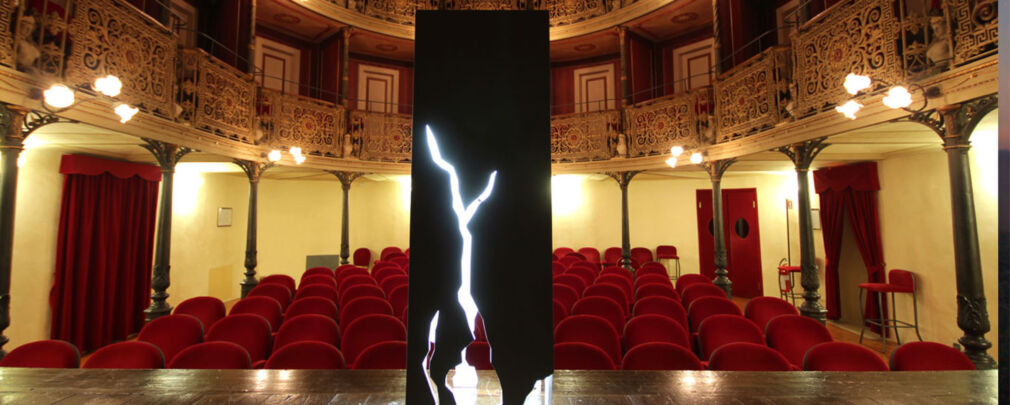 Close up of white wood finish on Molocko lamp showing light shining through geometric splits