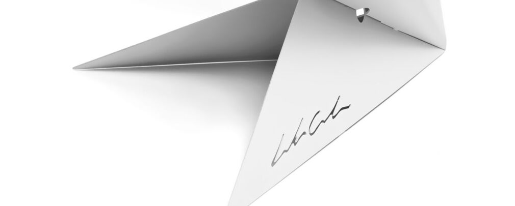 Detail of Aurora lamp showing sharp angles and LED light casting geometric shadows