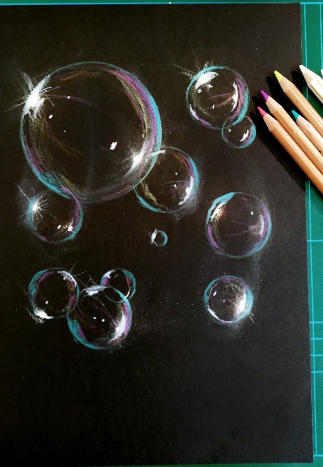 black papaer sketch with white pencil of coloured bubbles